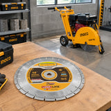 Ingco 405mm diamond floor-saw disc resting beside a compatible concrete-cutting floor saw in an organised equipment bay