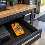 Ingco AKD1095 drill bit set stored in its orange case in an organized contemporary garage workshop.