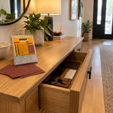 Finished wooden console drawer in an organised contemporary entryway with Ingco sanding sheets nearby