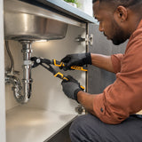 African American facilities technician using Ingco HPP38258 pump pliers on a compatible plumbing fitting beneath a utility sink.