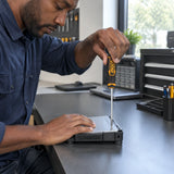 African American maintenance technician tightening a compatible Phillips screw with an Ingco PH1 screwdriver at a repair bench