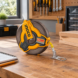 Ingco HFMT1820 fibreglass measuring tape resting on an organised home workshop bench