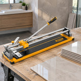 Ingco 600mm manual tile cutter resting beside ceramic tiles in a clean bathroom renovation workspace
