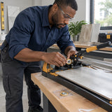 African American tile installer fitting an Ingco HTC04602B ball-bearing scoring wheel onto a compatible manual tile cutter.