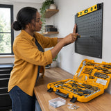 African American homeowner uses an Ingco HKTHP51758 screwdriver and spirit level to mount a pegboard panel.