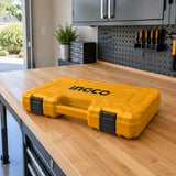 Closed yellow Ingco HKTHP21391 tool case resting on a workbench in an organized contemporary home garage.