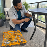 African American homeowner uses an Ingco HKTHP51498 ratchet and spanner to assemble a metal balcony table.