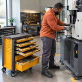 African American maintenance technician using a ratchet from the Ingco HTCS273561 tool chest on a workshop machine