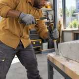 African American maintenance worker using an Ingco HCCL832519 flat cold chisel on supported masonry