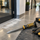Prepared concrete repair area with the Ingco HCC830419 pointed chisel resting nearby in a clean commercial corridor.