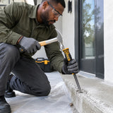 African American masonry technician using an Ingco pointed concrete chisel for controlled localised concrete repair.