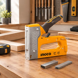 Ingco HSG1408 staple and brad gun resting on a tidy professional frame-making workbench.