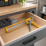 Ingco HCG1409 caulking gun stored in an organised contemporary utility-room tool drawer.