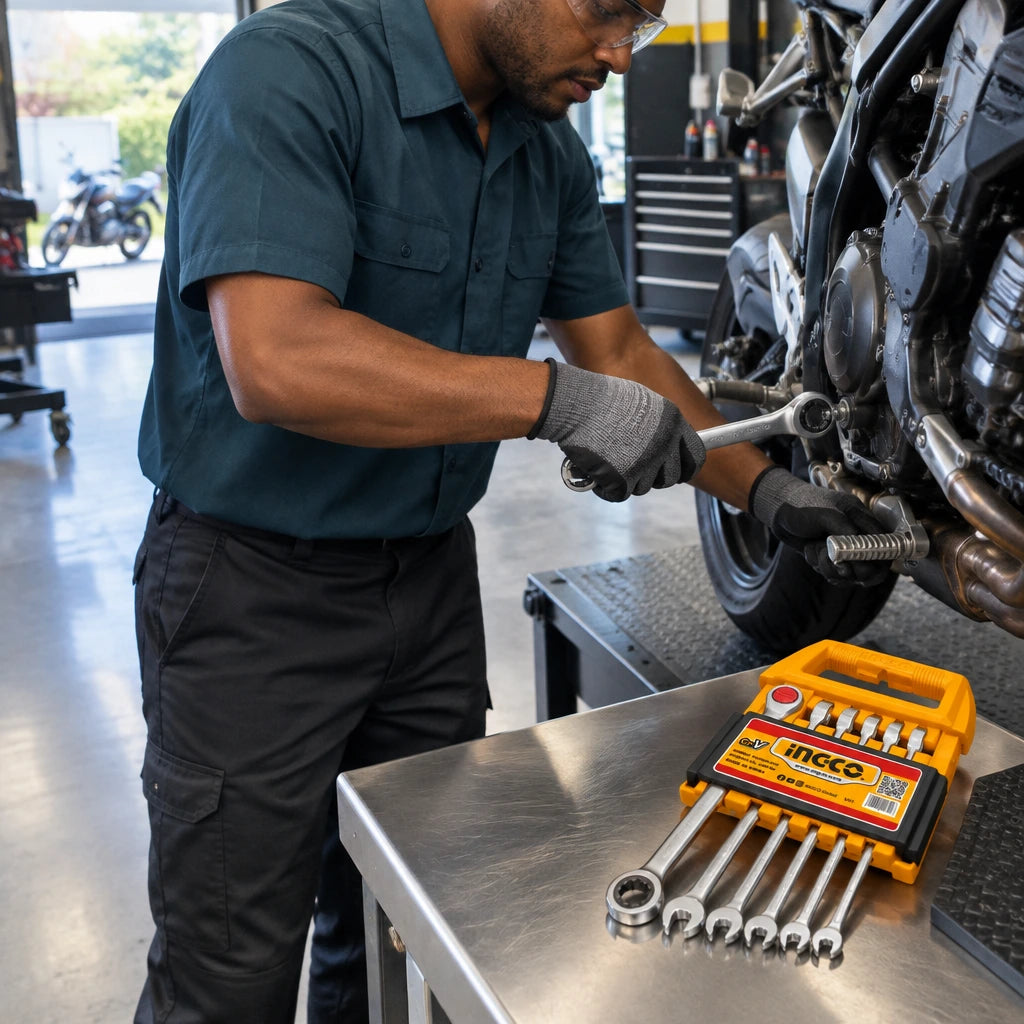African American motorcycle technician using an Ingco 17mm ratchet spanner on a compatible fastener in a clean service bay