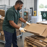 African American recycling worker wearing Ingco HGVK65 gloves while moving flattened cardboard to a pallet