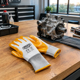Completed mechanical assembly ready for inspection beside resting Ingco HGNG64 nitrile work gloves.