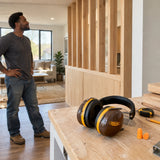 Completed timber renovation work with Ingco HEM3328 earmuffs resting on the nearby workbench in a refined contemporary interior.