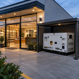Contemporary retail shop remaining illuminated beside a resting Titan 33kVA backup generator at dusk