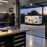 Illuminated equipment-repair workshop remains operational beside a resting Titan silent diesel generator at dusk.