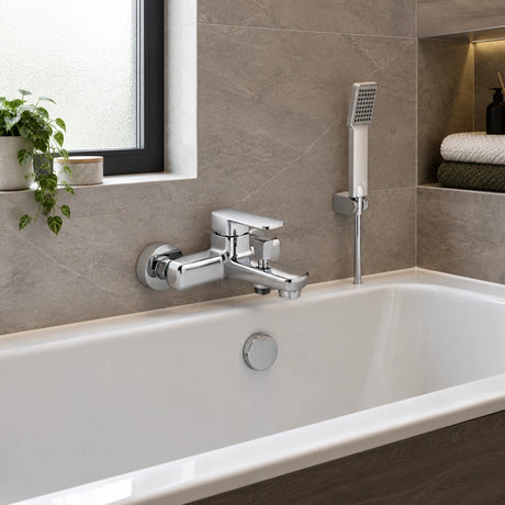 Vado chrome bath shower mixer and handheld shower installed beside a contemporary bathtub