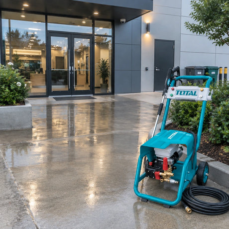 Clean commercial building entrance with the Total TGT11176 pressure washer resting beside the freshly washed paving