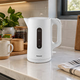 Panasonic white K101 electric kettle resting on a contemporary kitchen beverage counter