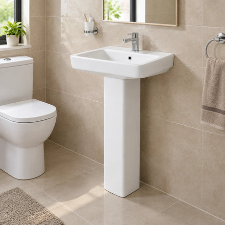Nate BR Fabia full-pedestal ceramic basin installed on the wall in a compact finished bathroom