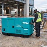 Electrician checking a Total TP2150K3 silent diesel generator powering a commercial construction site