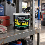 Closed Abro #3 Super Heavy Duty Grease tin resting on a shelf in a Ghanaian automotive workshop