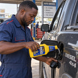 Mechanic pouring Abro Diesel Injector Cleaner into the fuel filler of a diesel pickup during routine service