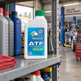 Capped Abro Premium ATF 1 litre bottle stored on a shelf in a Ghanaian auto repair workshop