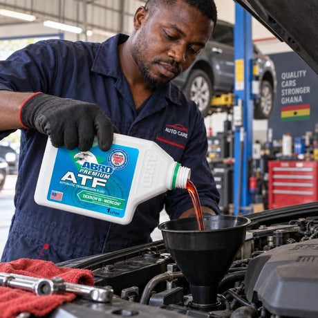 Technician pours Abro Premium Dexron III Mercon ATF from a 1 litre bottle into a vehicle transmission service point