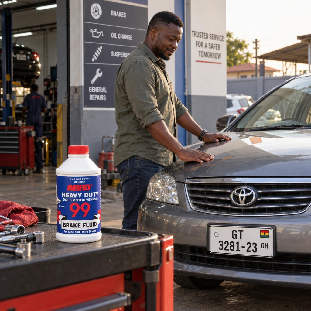 Serviced vehicle ready to drive with Abro 99 DOT 3 brake fluid bottle on a nearby workshop cart