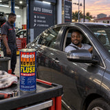 Vehicle owner beside a serviced car with an Abro MF-390 Motor Flush can on a garage service cart