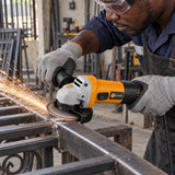 Ghanaian metalworker using a Coofix corded angle grinder to smooth a weld on a steel gate frame