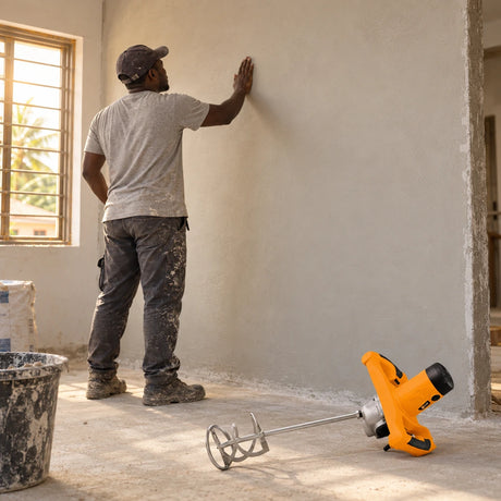 Freshly plastered home wall inspected beside a resting Coofix electric mortar mixer
