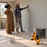 Finished plaster wall inspected by a Ghanaian homeowner with a Coofix electric mortar mixer resting in the foreground