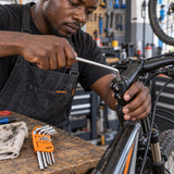Ghanaian bicycle technician using a Coofix ball-end hex key on a recessed stem fastener