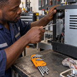 Ghanaian technician using a Coofix extra-long Torx key on a recessed machine fastener