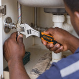 Ghanaian technician using a Coofix 6-inch adjustable wrench to tighten a sink plumbing fitting