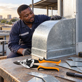 Finished curved galvanized metal panel inspected beside Coofix right-cut aviation snips in a Ghanaian workshop