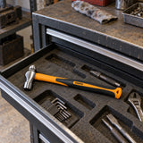 Coofix ball-pein hammer resting in an open tool drawer in a working metal workshop