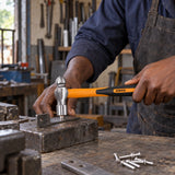 Worker using a Coofix ball-pein hammer to peen a metal rivet on a workshop bench
