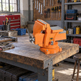 Coofix orange 8-inch bench vice installed on a sturdy workshop bench in a Ghanaian repair workspace