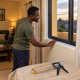 Finished window sealant repair with a Coofix caulking gun resting in the foreground of a Ghanaian home