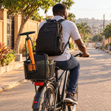 Ghanaian cyclist riding away with a Coofix hand inflator visible beside the ready bicycle