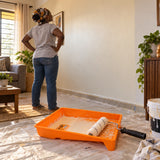 Freshly painted home wall with a Coofix orange paint tray resting in the foreground