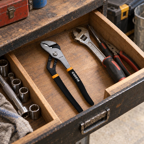 Coofix 12-inch pump pliers resting in an organized workshop tool drawer before plumbing work