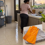 Clean utility area after household cleaning with Coofix orange PVC gloves resting on a cloth