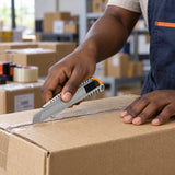 Ghanaian worker using a Coofix aluminium snap-off knife to cut a cardboard carton seam
